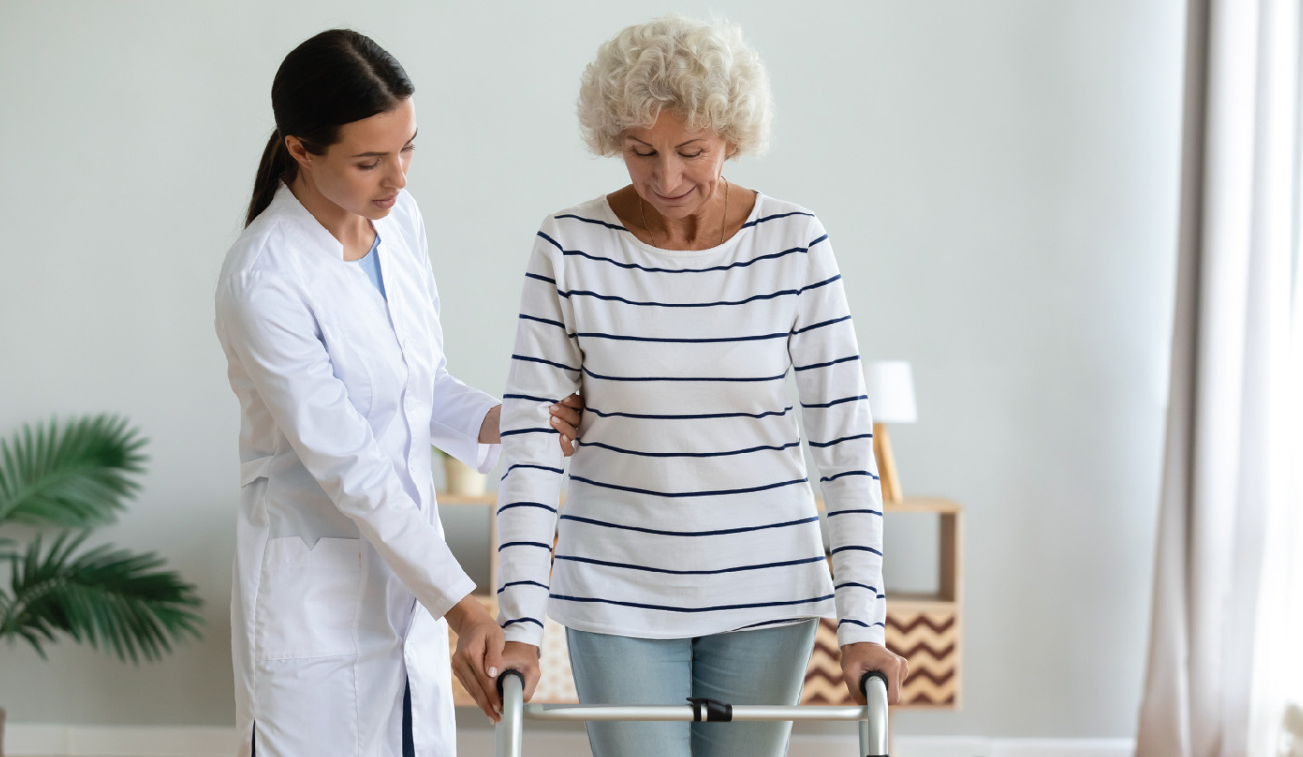 Westminster at Home nurse assists senior patient in Lynchburg, Virginia with using her walker properly through physical therapy