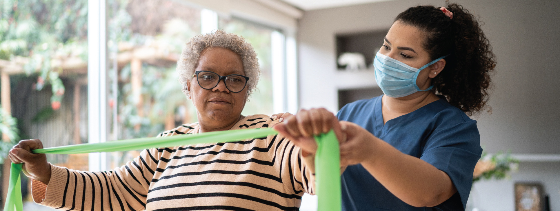 Westminster at Home nurse assists senior patient in Lynchburg, Virginia with therapy session using resistance bands